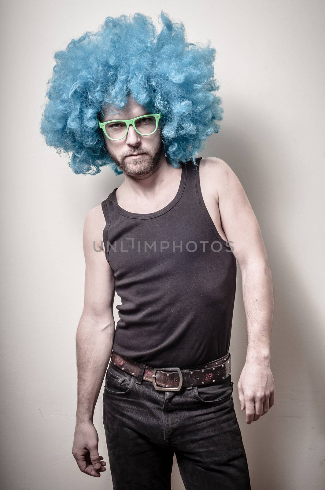 hipster stylish funny man with blue wig on gray background