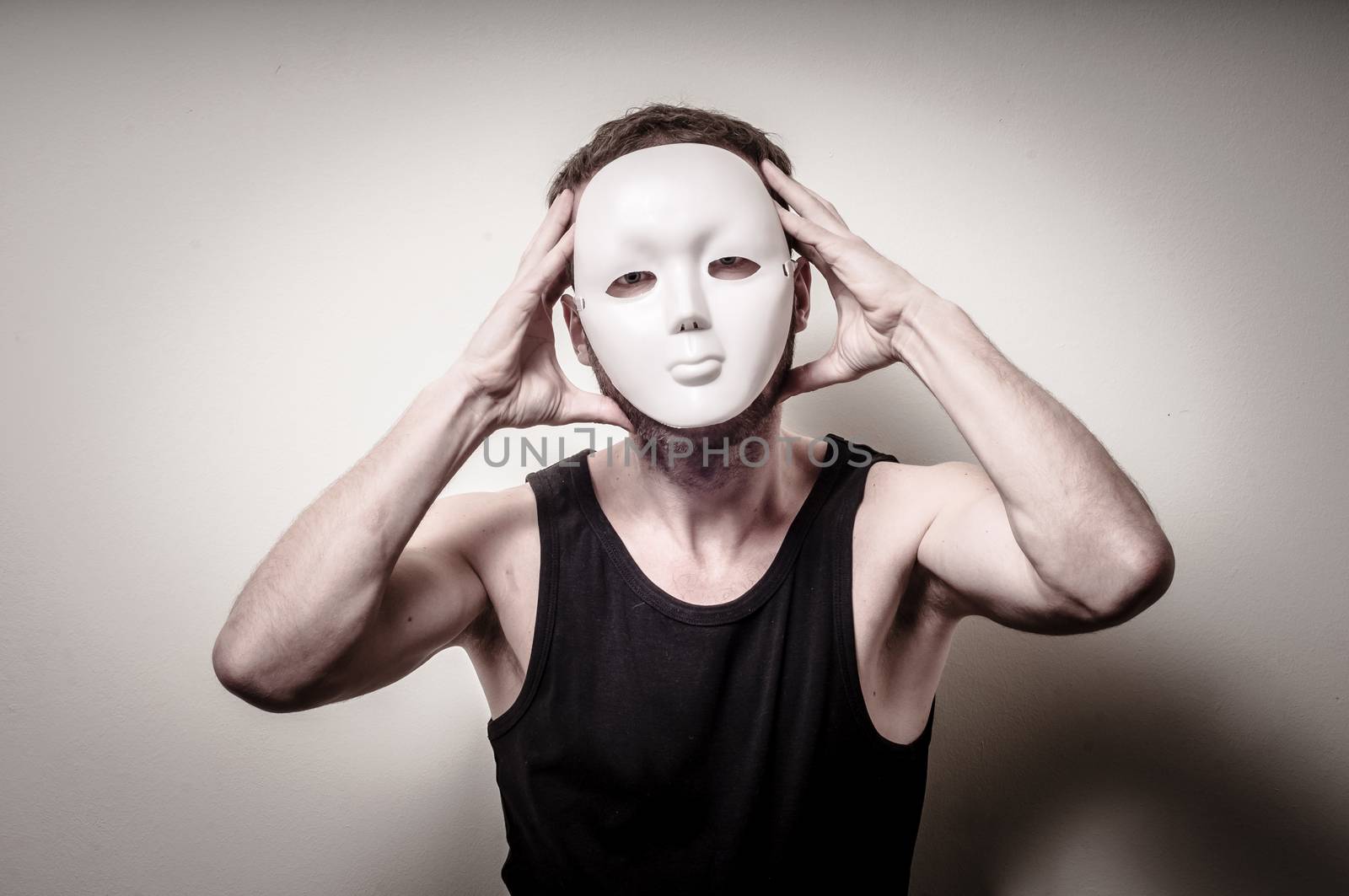 man with white mask on gray background