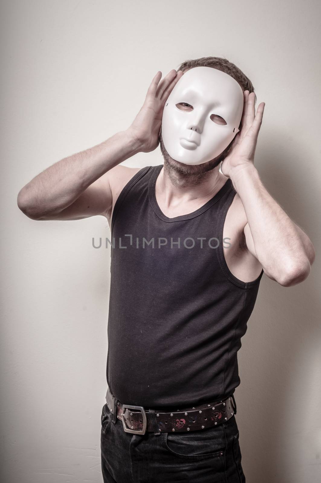man with white mask on gray background