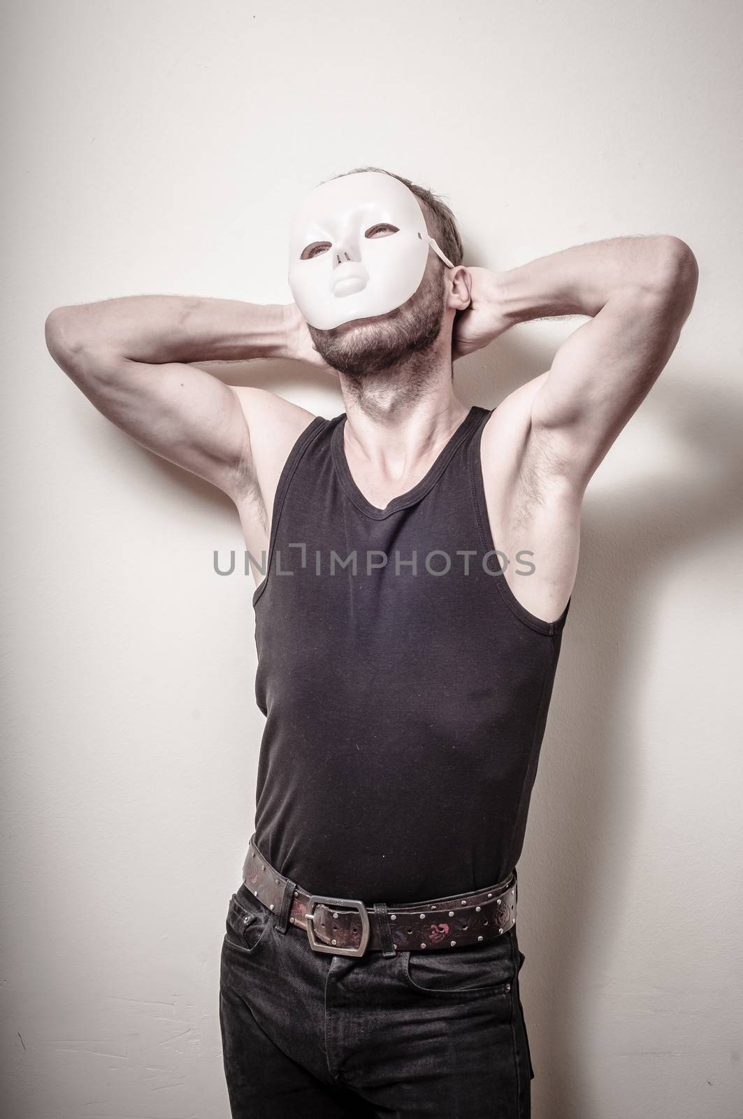 man with white mask on gray background