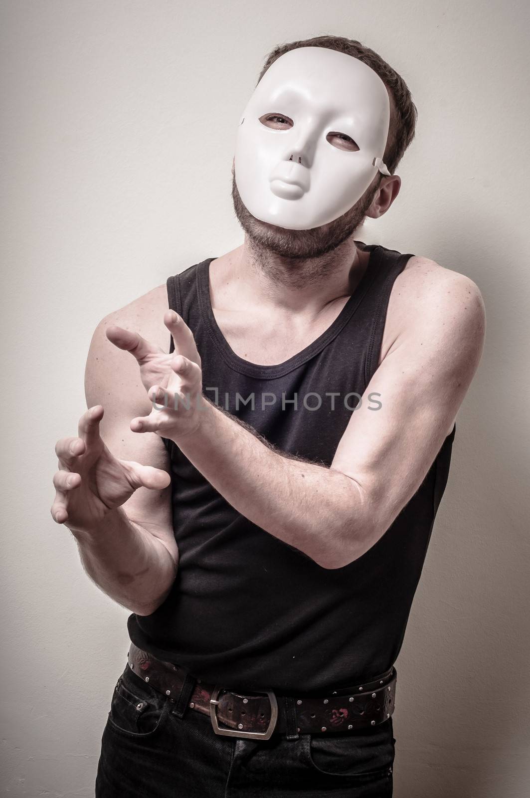 man with white mask on gray background