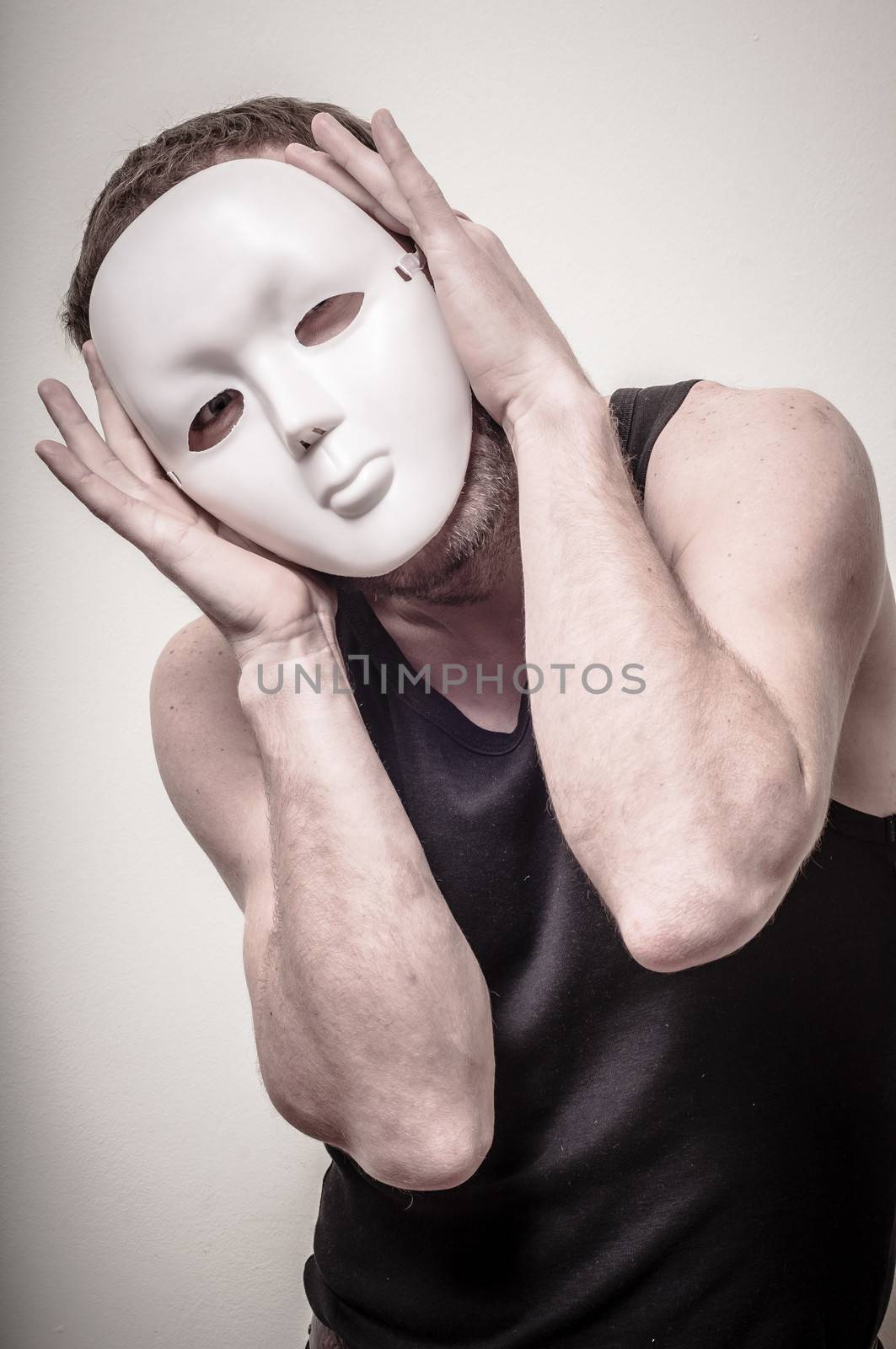 man with white mask on gray background