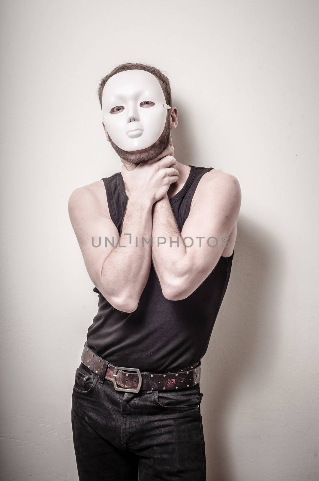 man with white mask on gray background