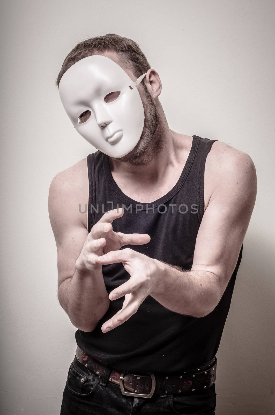 man with white mask on gray background