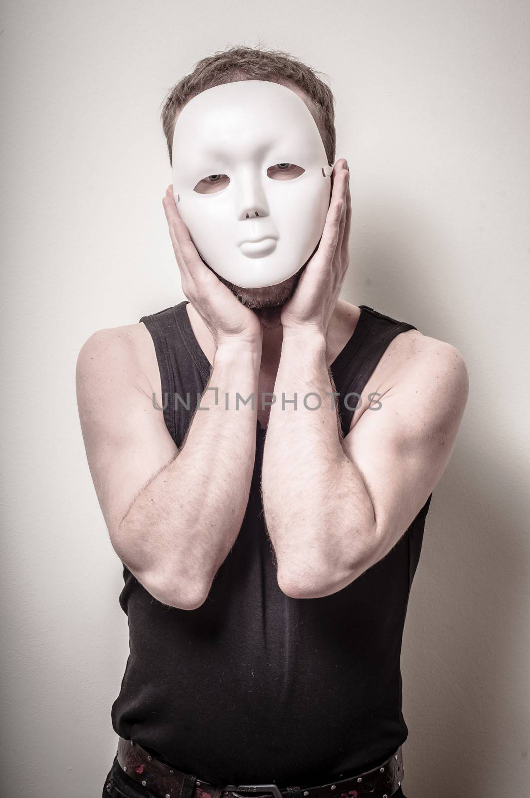 man with white mask on gray background