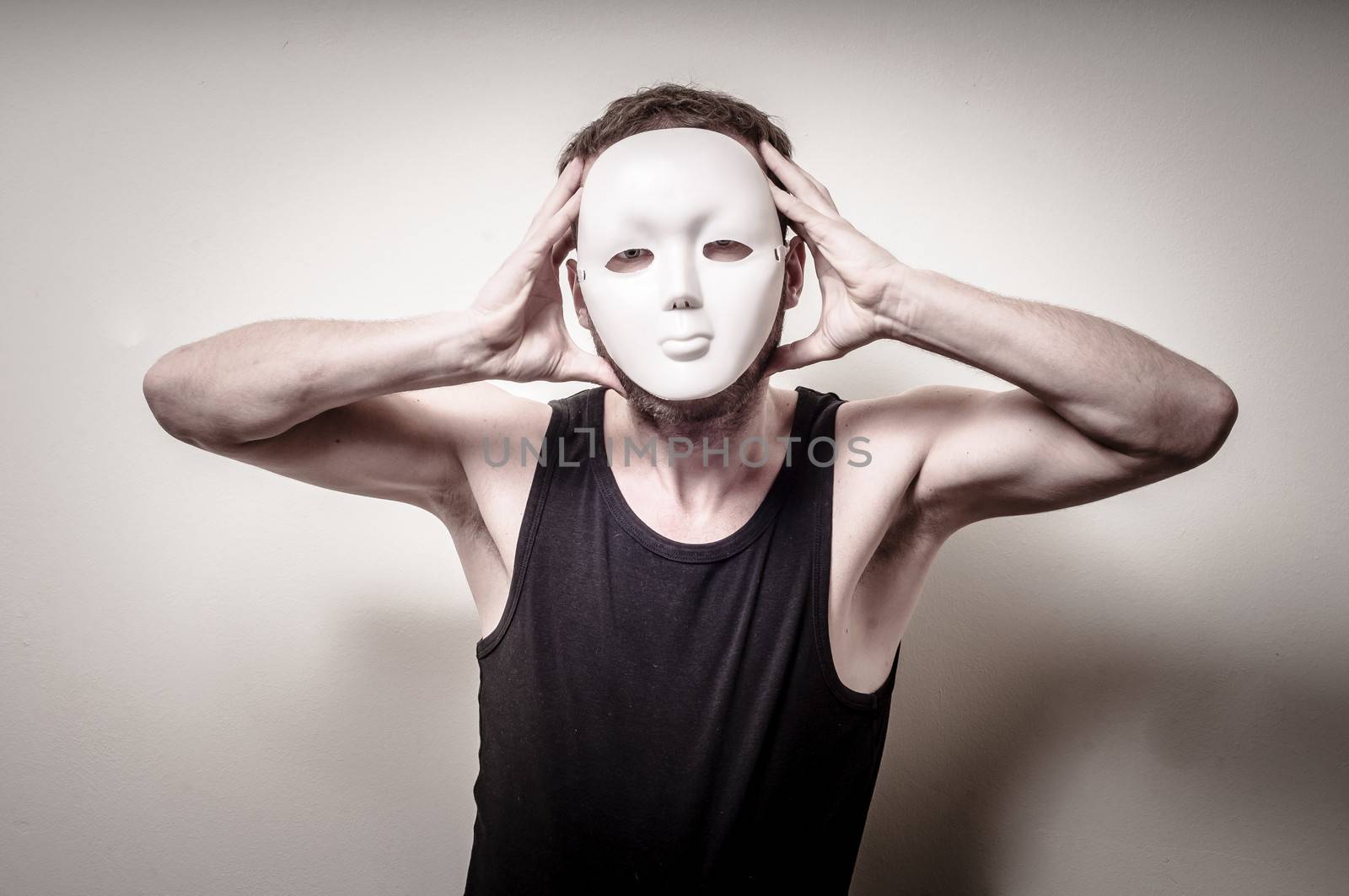 man with white mask on gray background