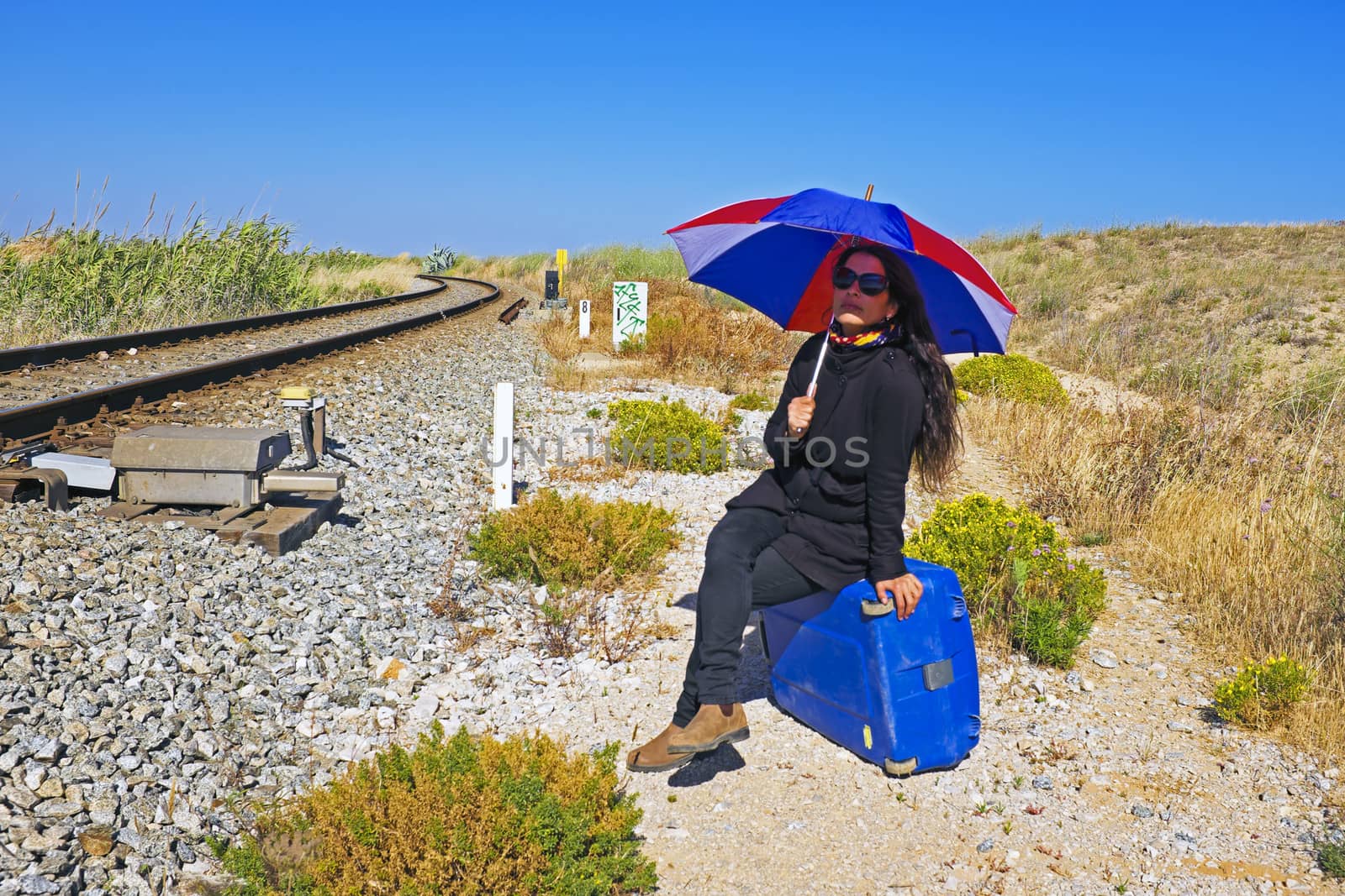 Woman waiting for the train in the sun by devy