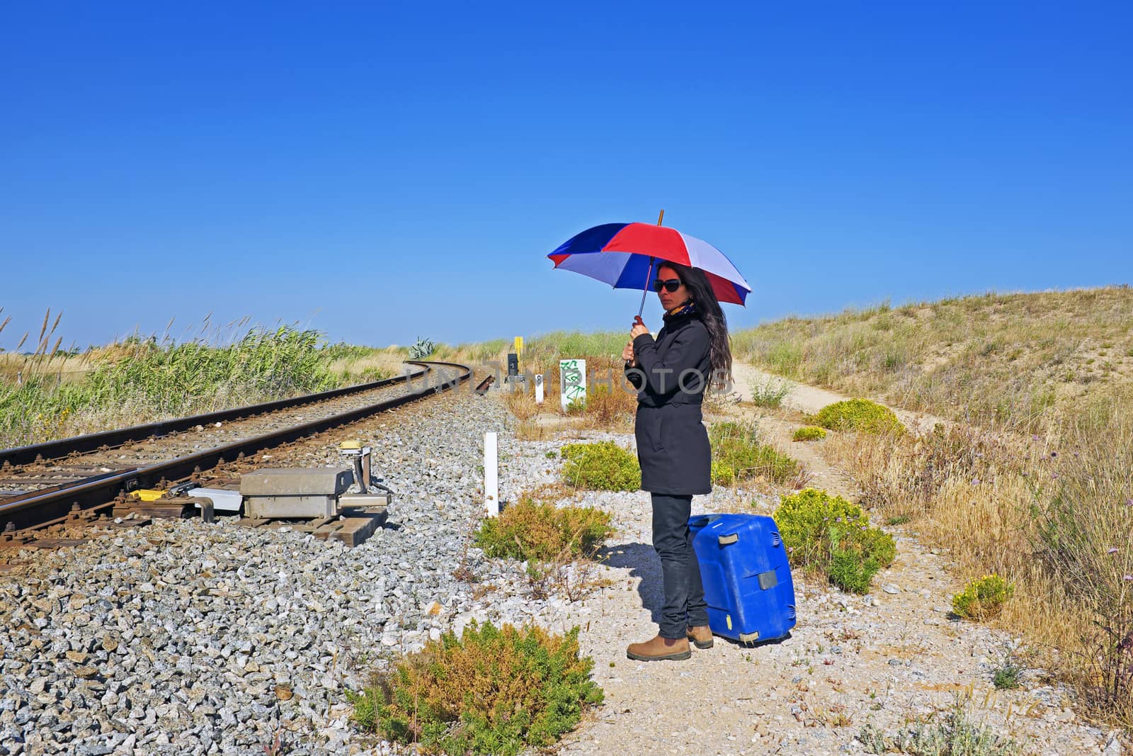 Woman waiting for the train in the sun by devy