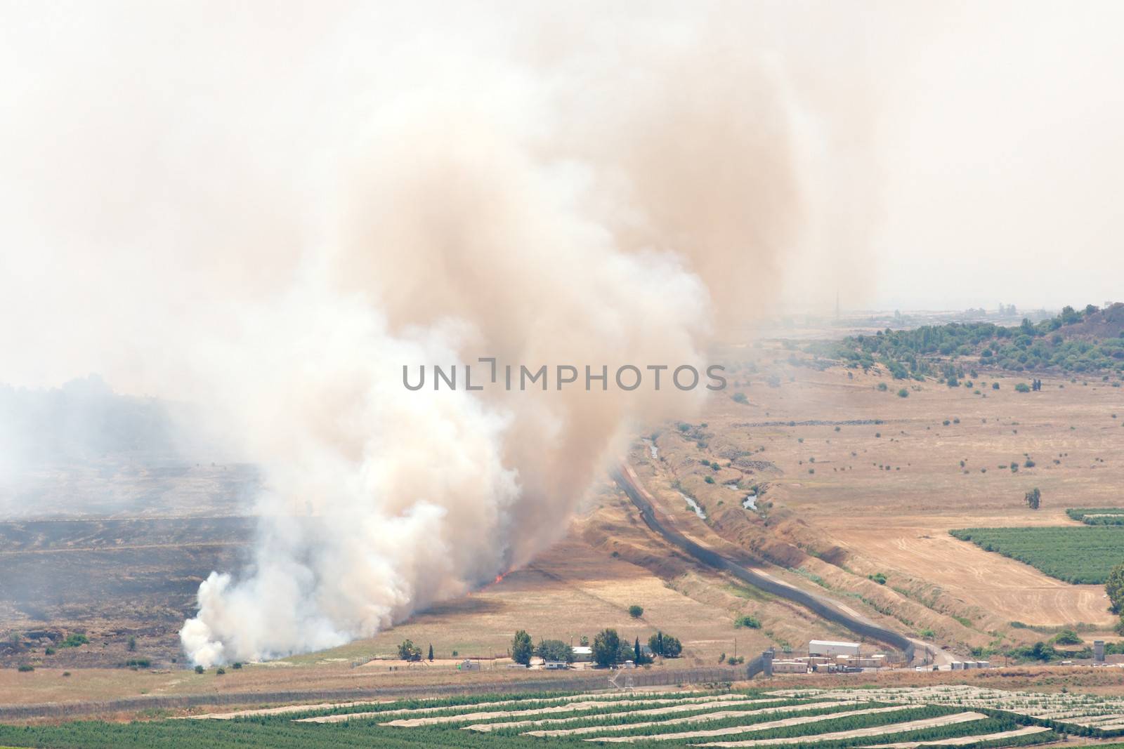 JUNE 06: Fire after shelling on battlefield in Syria on June 06, 2013 in Qunaitira, Syria