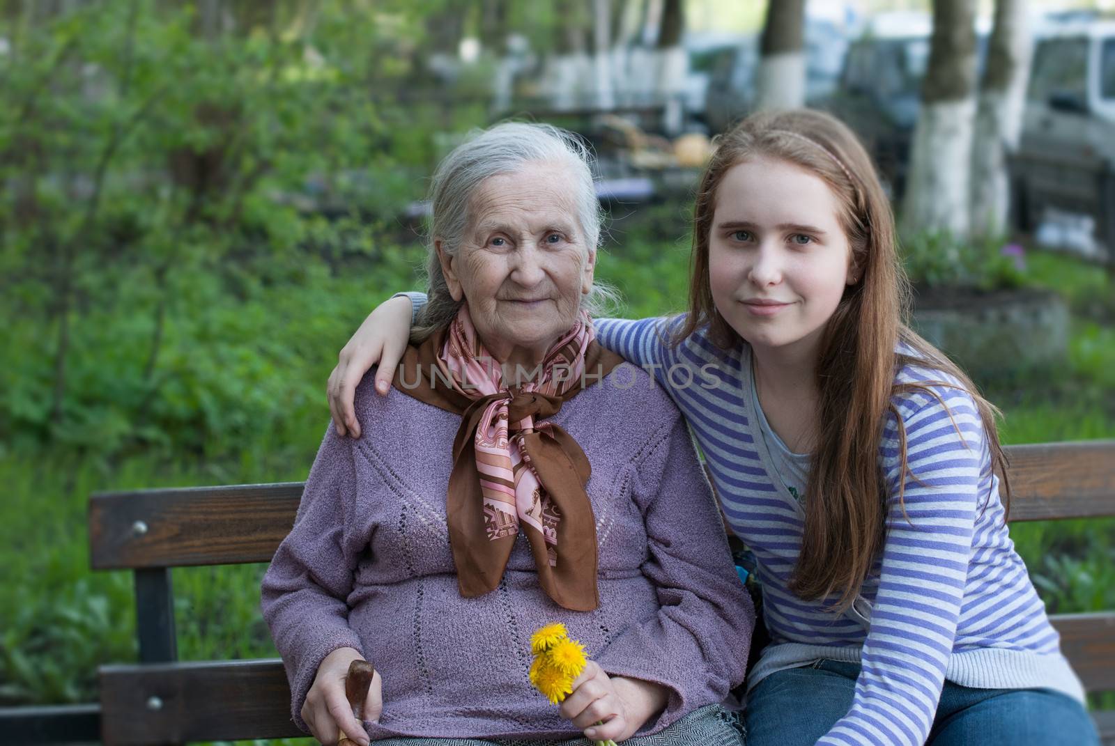 Grandmother and granddaughter laughing in the park in summer