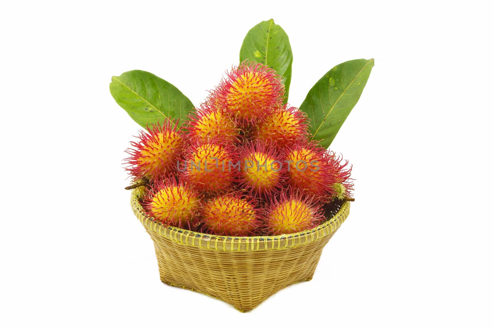 Organic rambutan Thai fruit in wicker basket isolated on white 