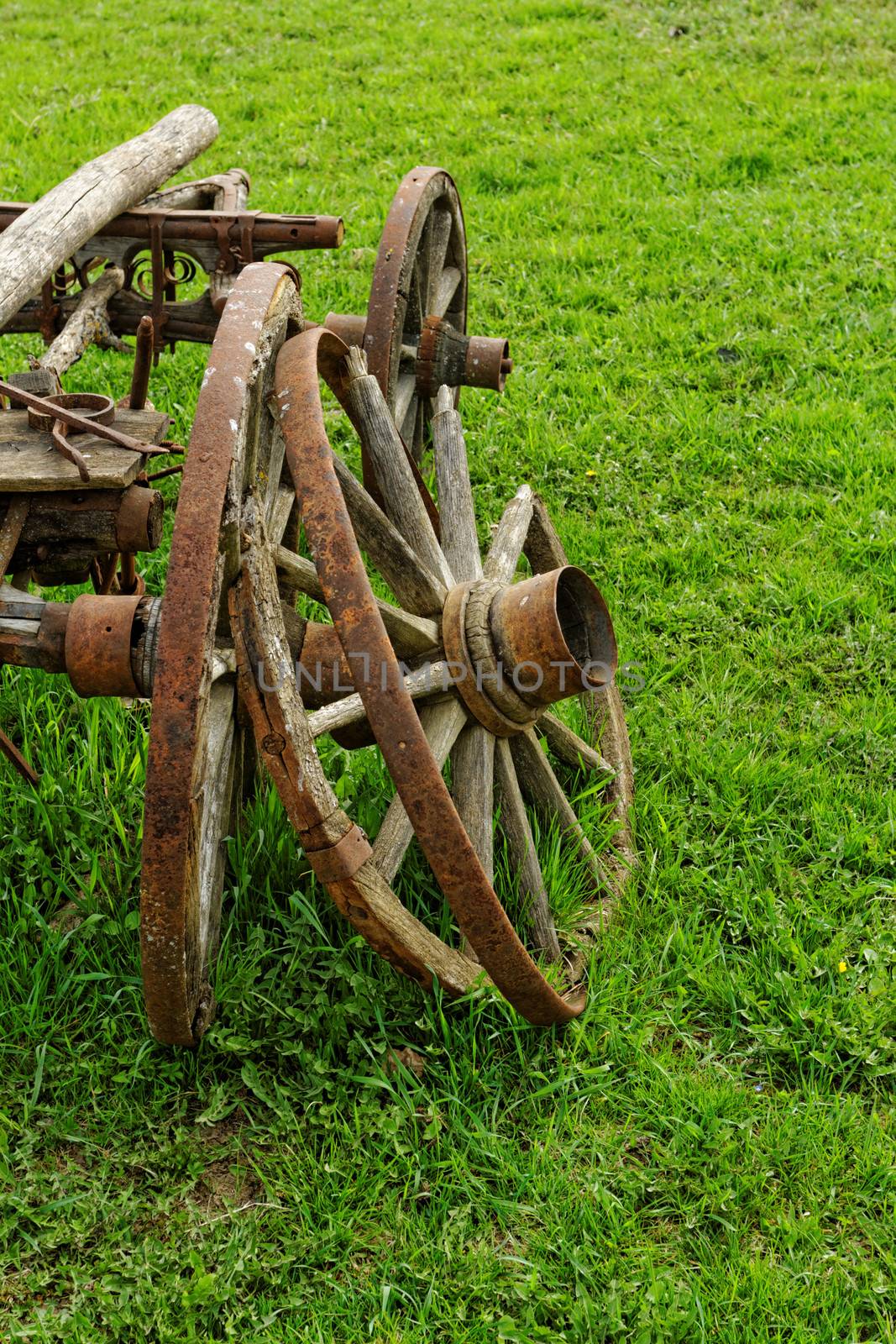 old broken wooden wheel spokes, side by chariot