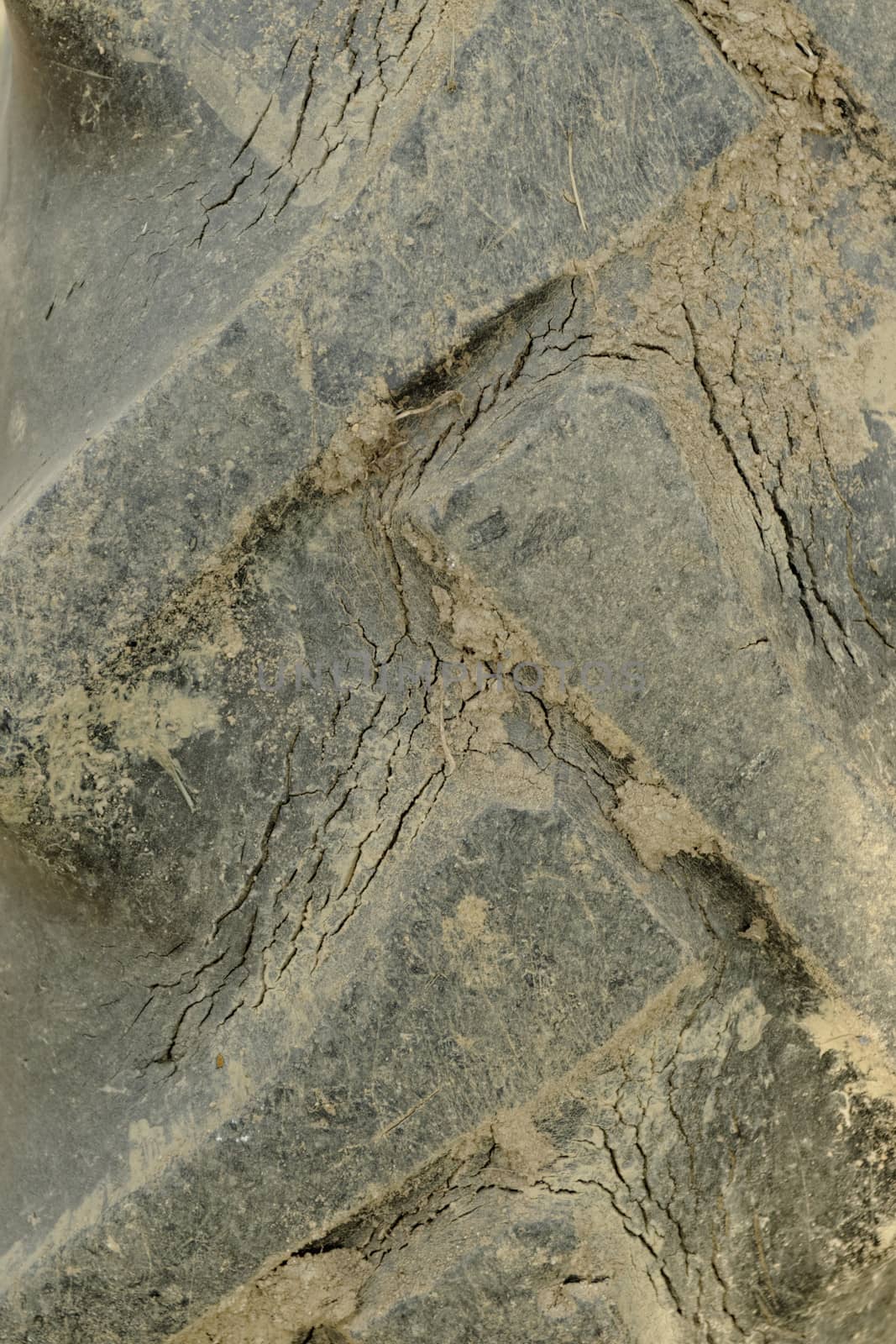 Close-up of tractor tire tread as background.