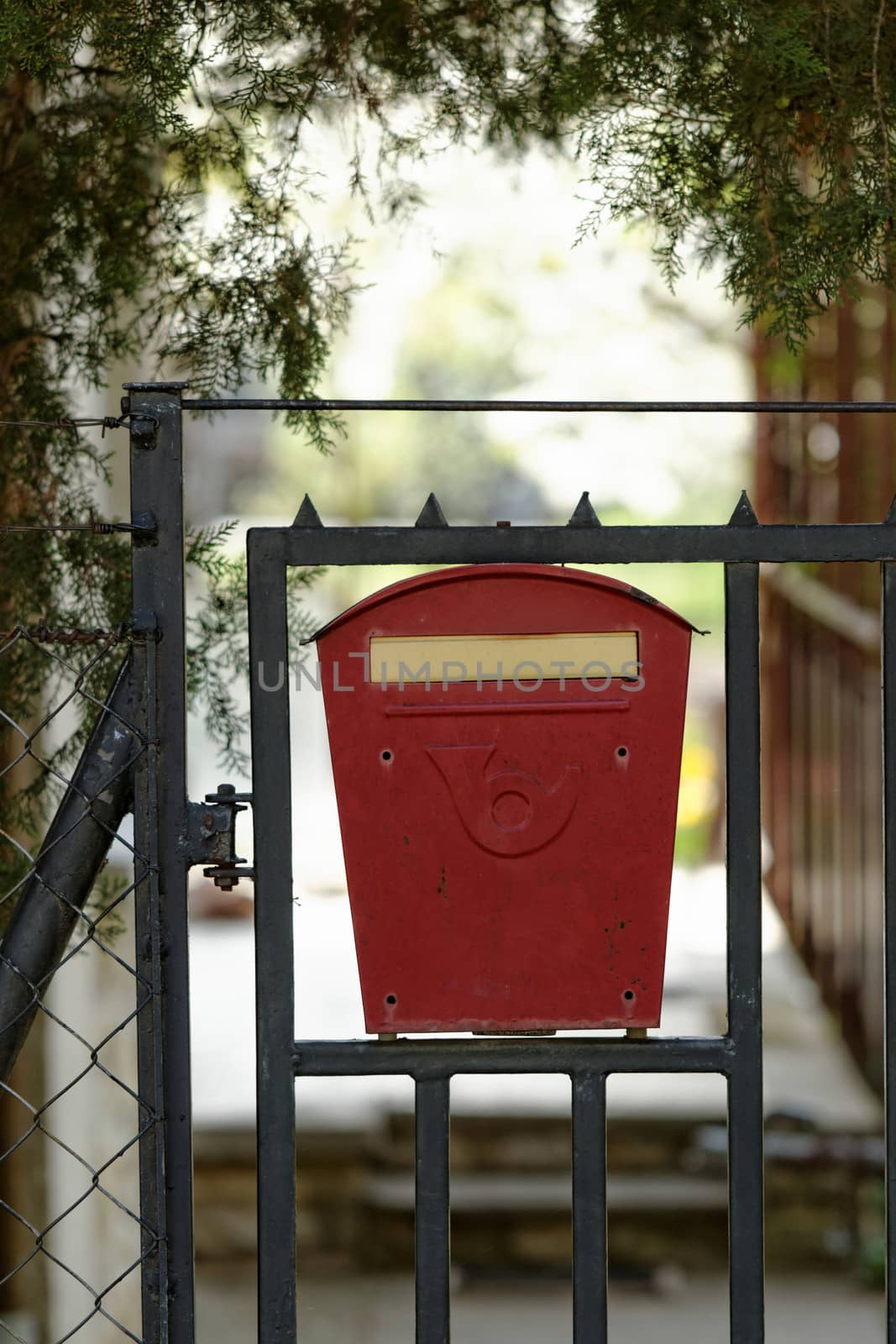 red steel mailbox on the fence