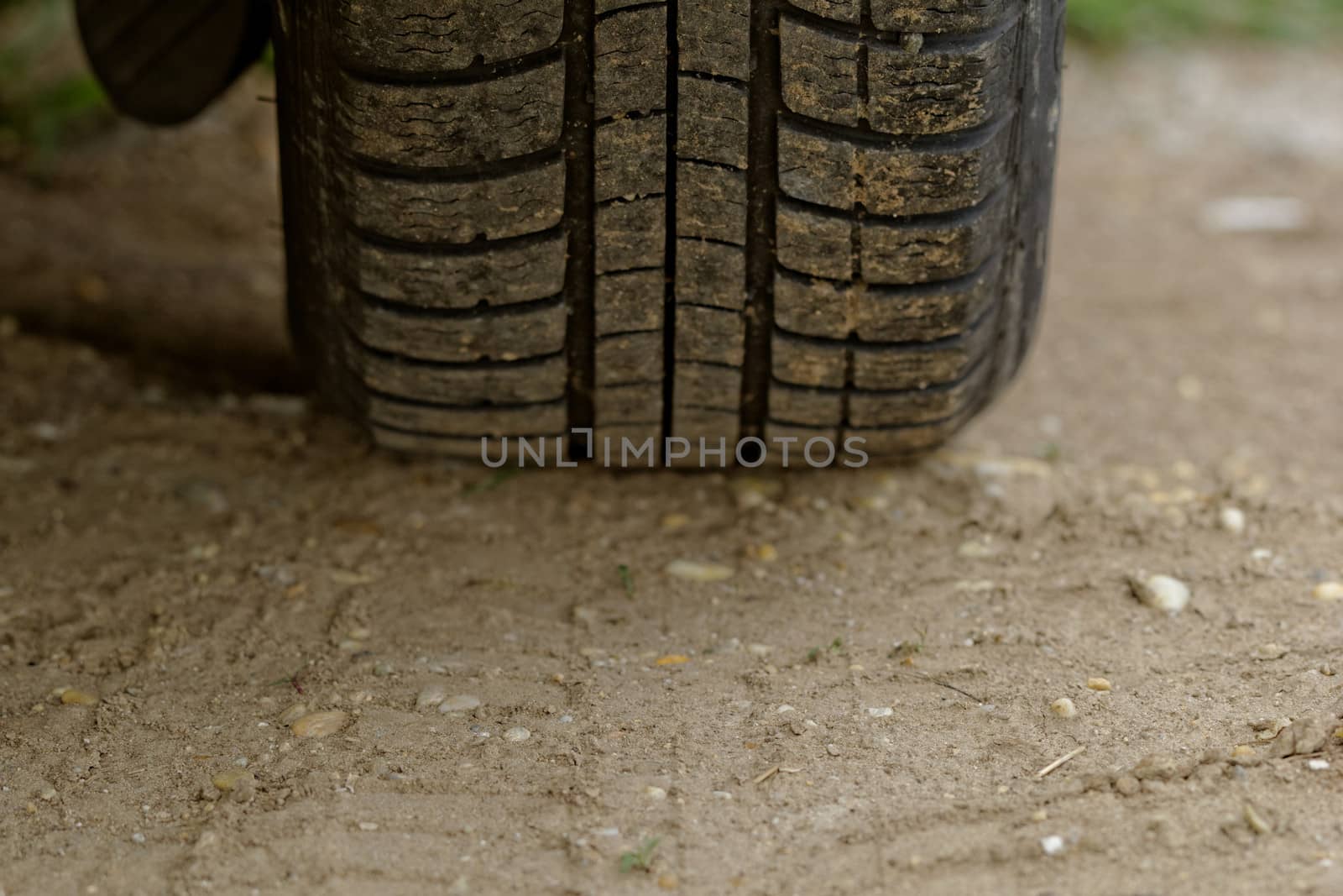Car wheels on a dusty road detail by NagyDodo
