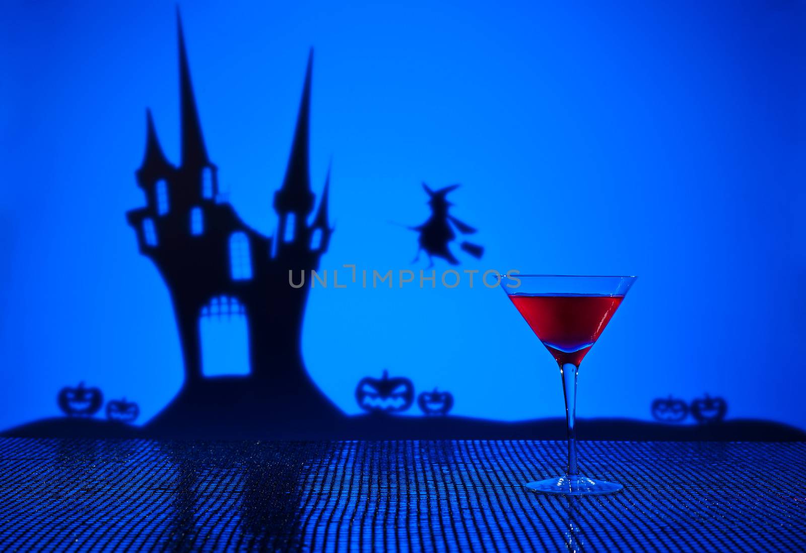 Halloween haunted house witch and a Cosmopolitan cocktail