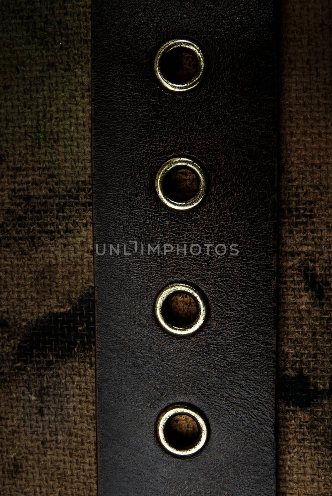 Close-up photo of the leather belt on a dirty background