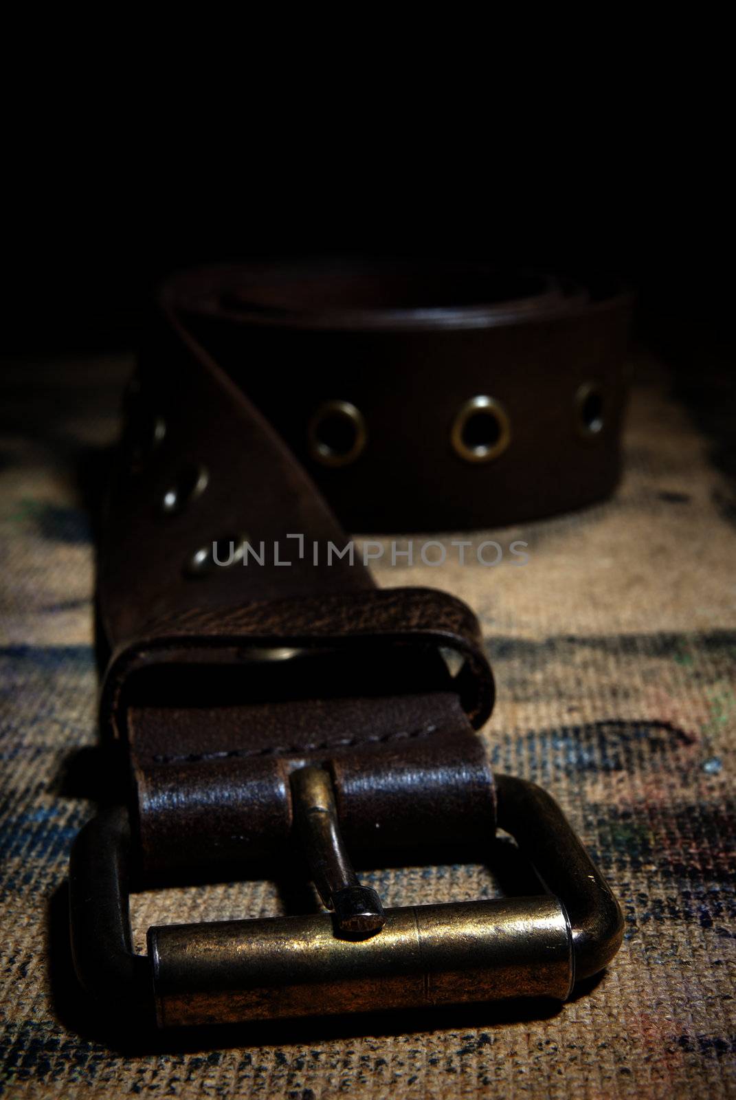 Close-up photo of the leather belt on the dirty surface