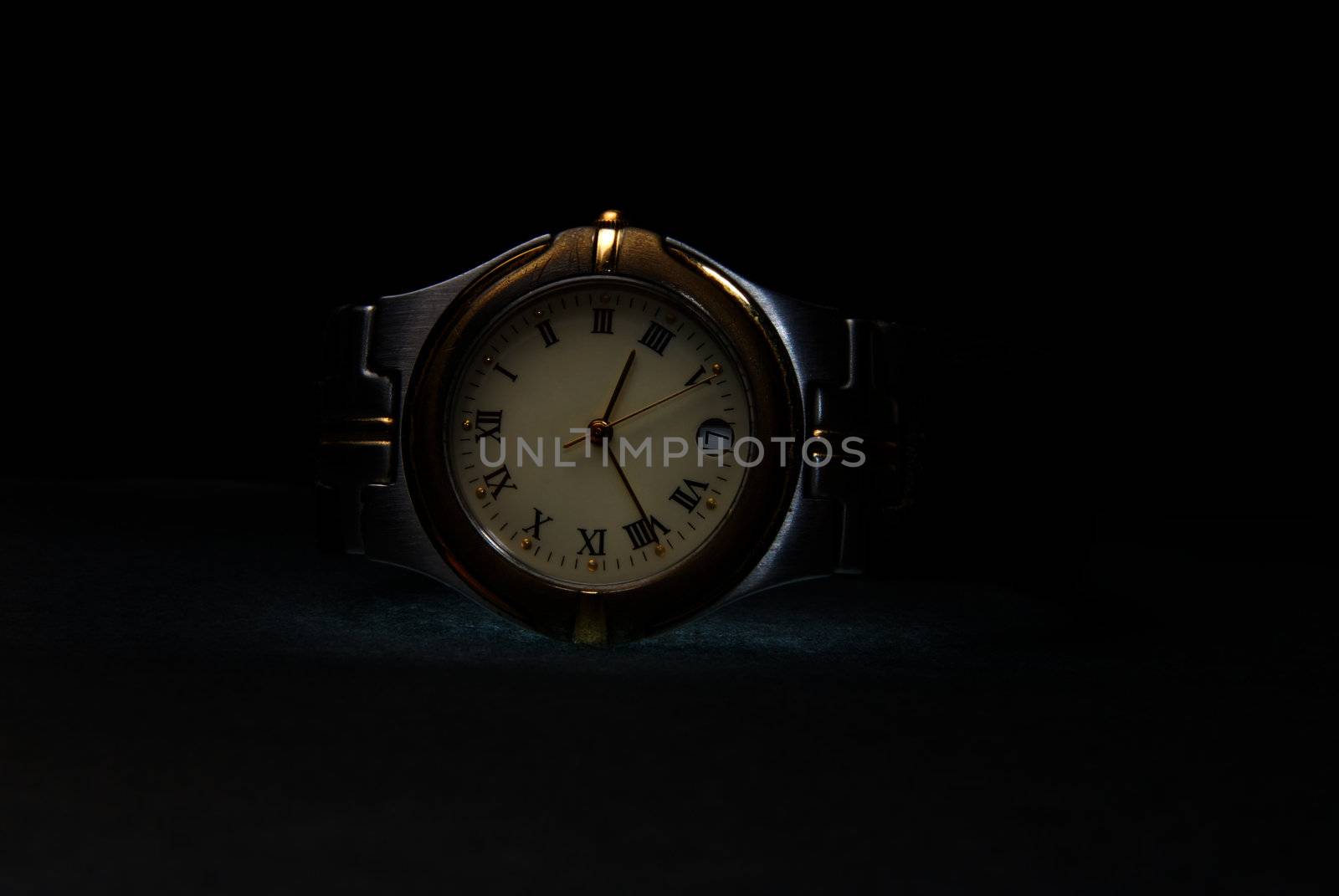 Silver wristwatch with chromium body on a dark background