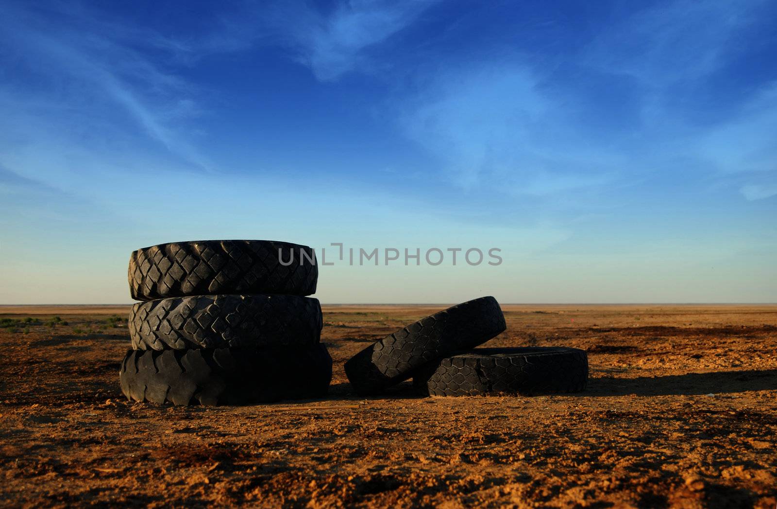 Photo of five old vehicle tires outdoors