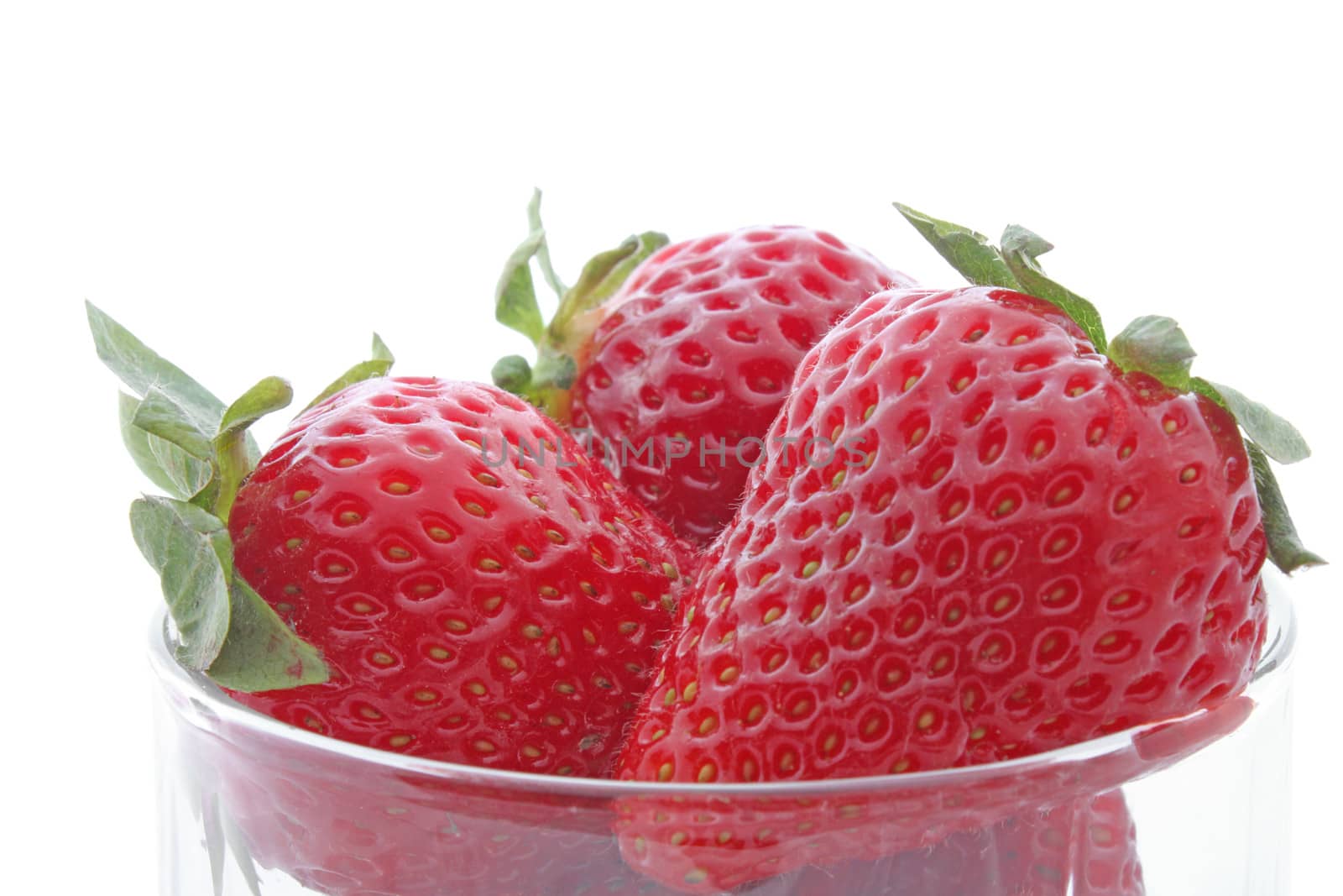 close up of strawberries in a glass