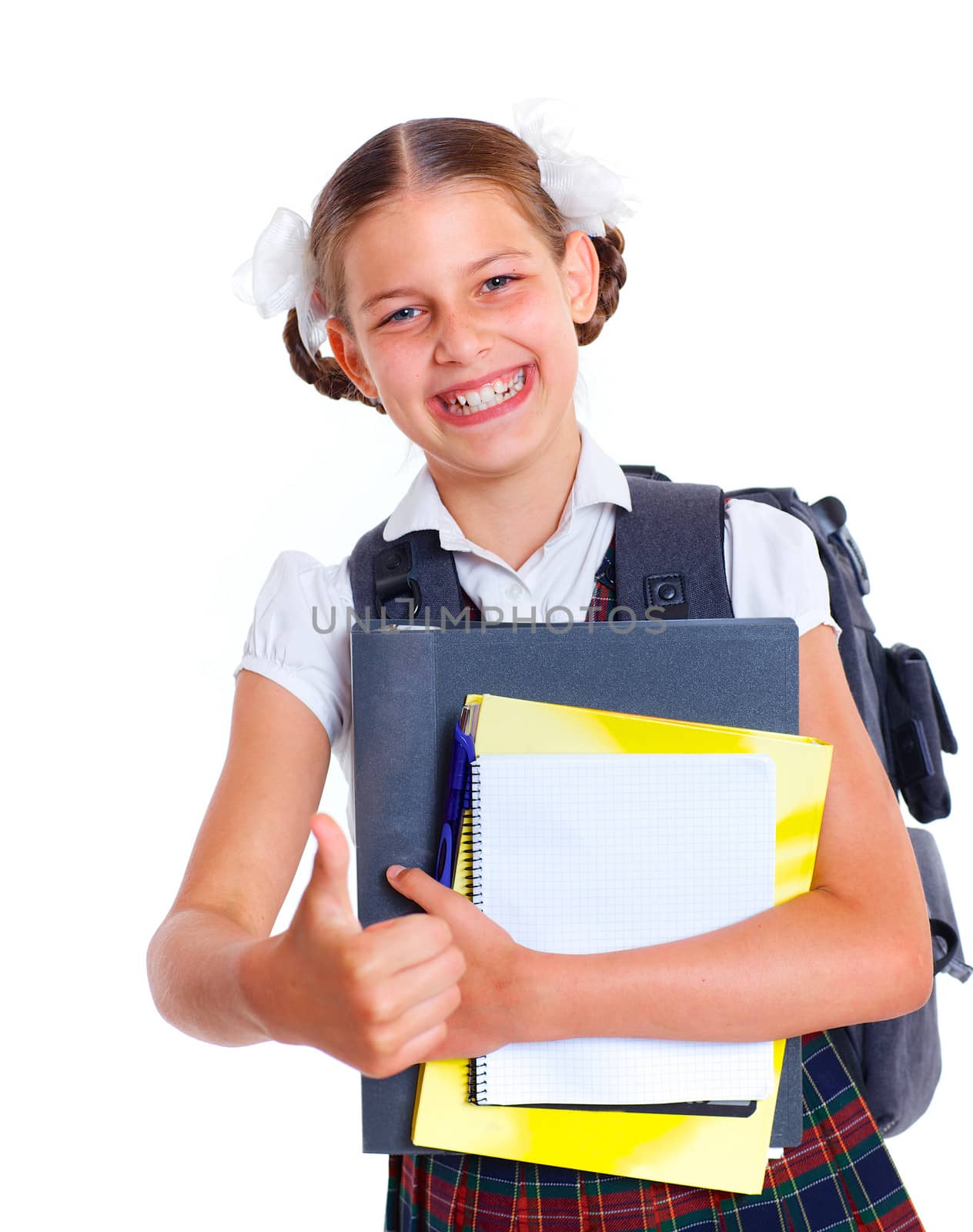 Education theme. Joyful schoolgirl smiling happily with backpack holding book