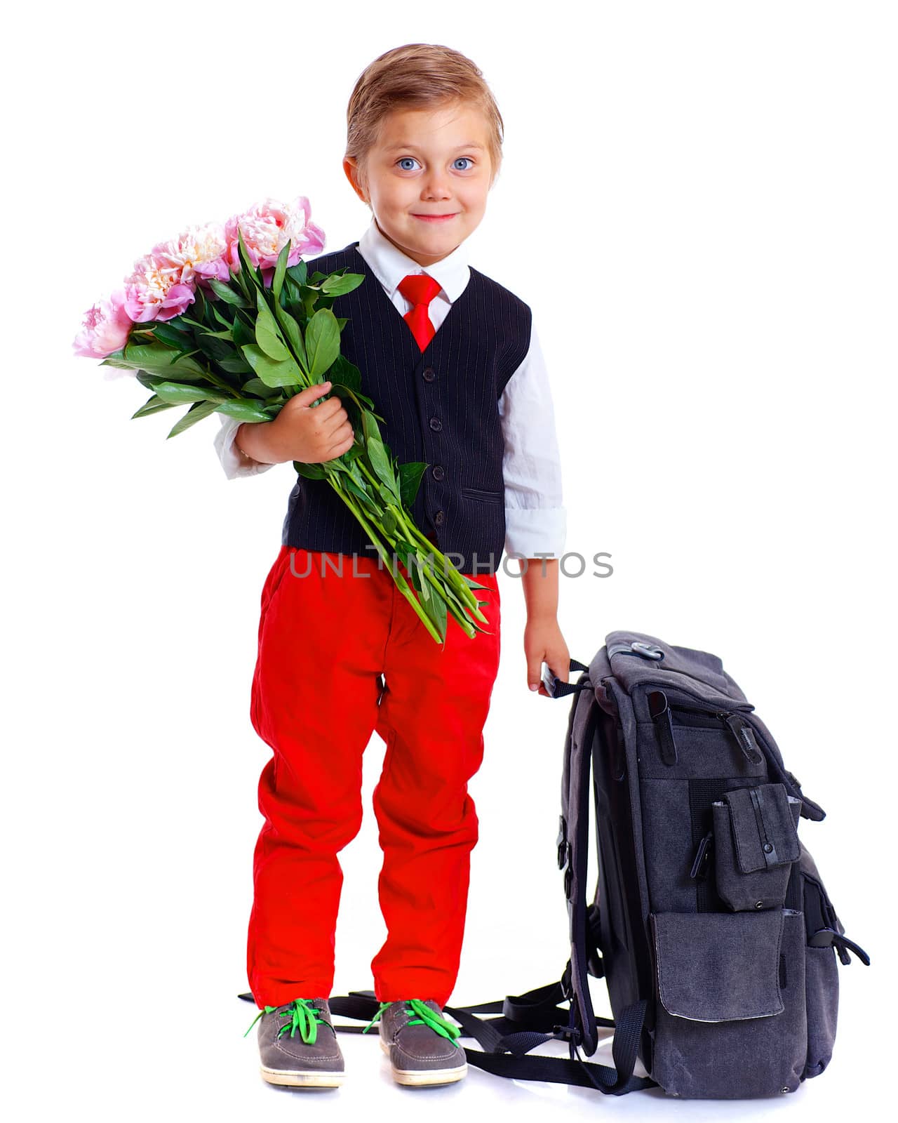 Happy schoolboy with flower and backpack isolated on white background