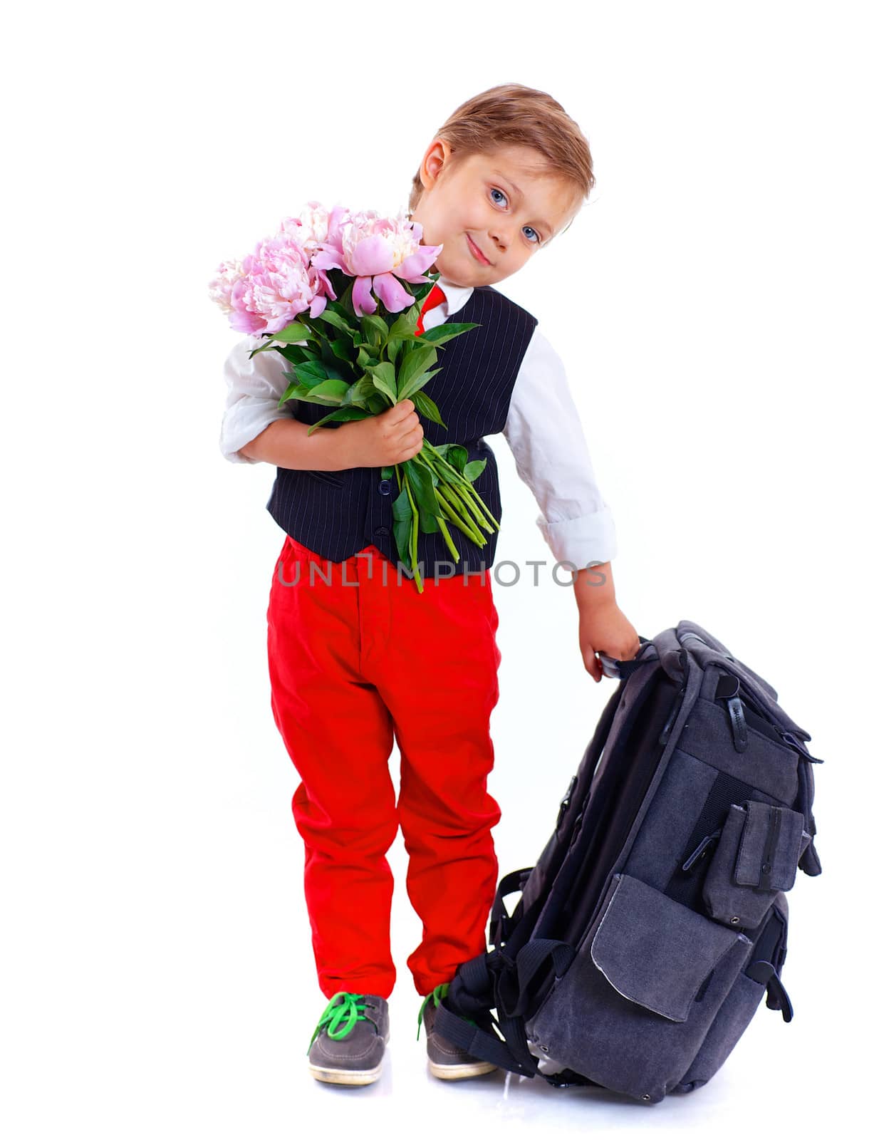 Happy schoolboy with flower and backpack isolated on white background