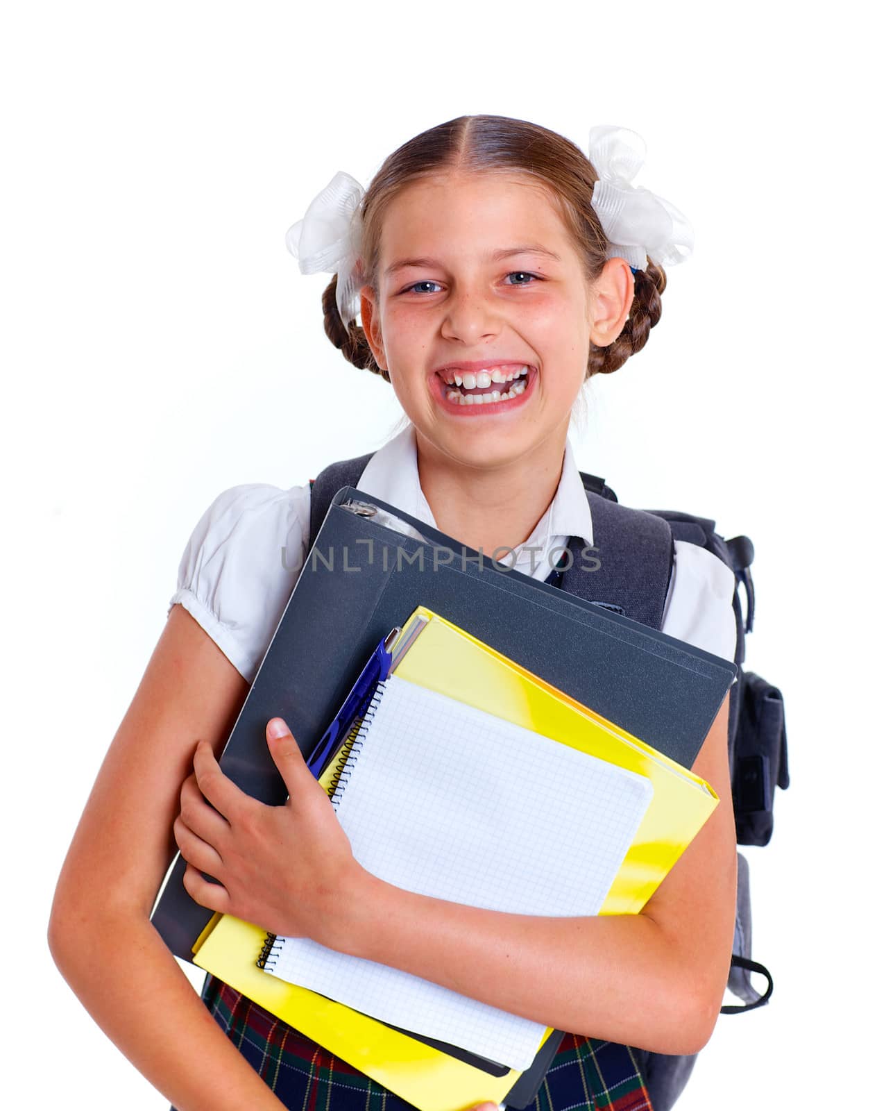 Education theme. Joyful schoolgirl smiling happily with backpack holding book