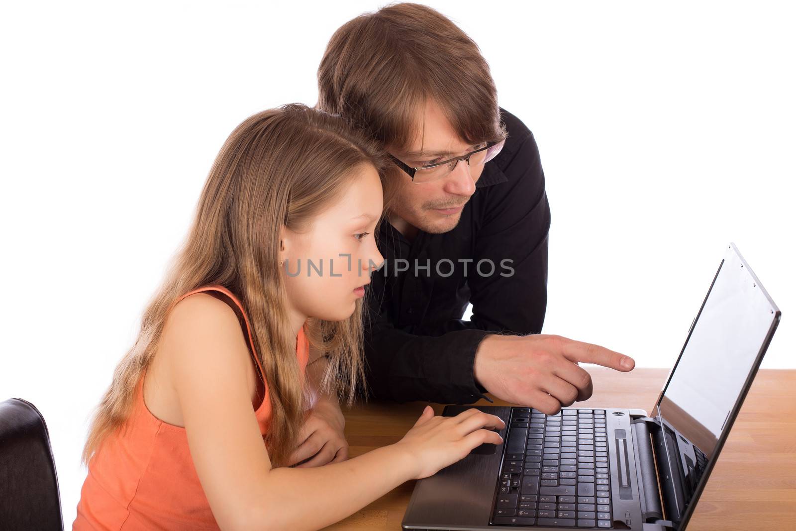 Young father and daughter work together on a project with a laptop on a wooden table. Isolated on white background.