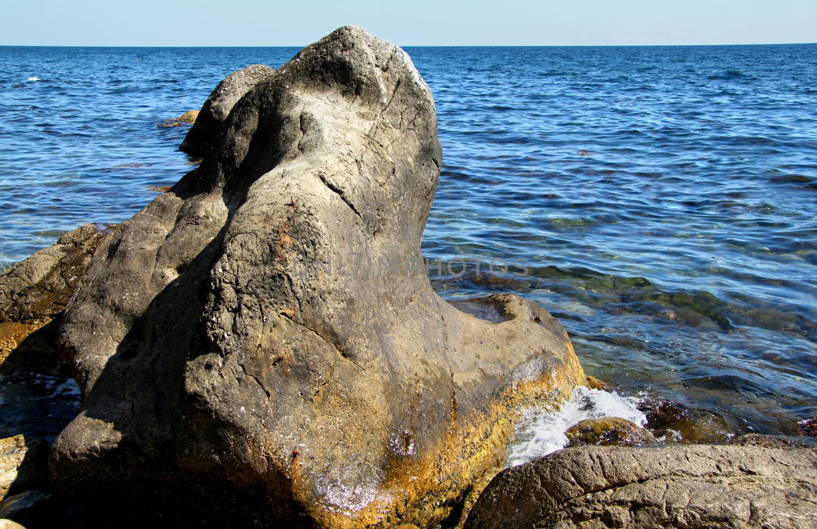Big beautiful stone on a background of the sea