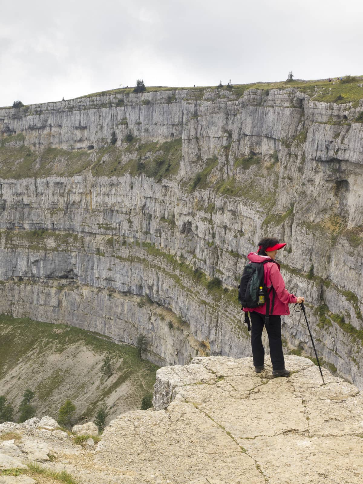 CREUX DU VAN, NEUCHATEL, SWITZERLAND - SEP 9: An unidentified hiker look at the natural rocky cirque of Creux du Van on September 9, 2010 in Neuchatel, Switzerland.