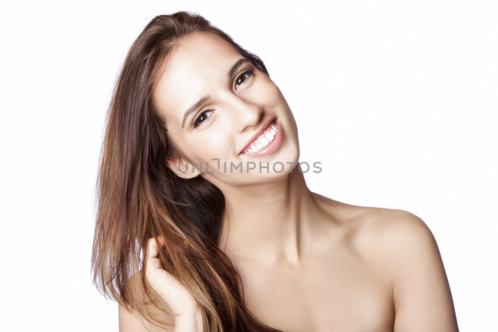 Beautiful happy smiling woman showing teeth with great skin touching her hair, skincare and haircare concept, isolated.