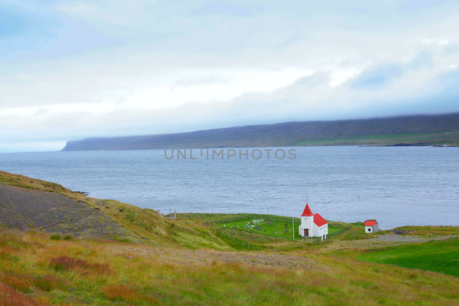 Small white church near the ocean, Iceland. Summer day.