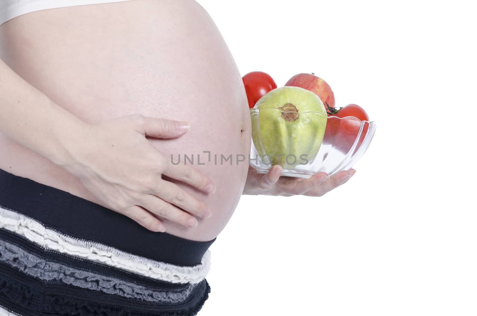 Pregnant woman with fresh fruit isolated over white background