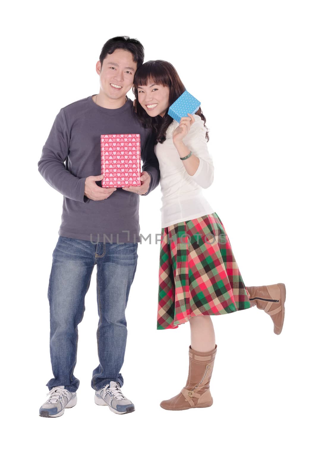 Young couple with gift over white background