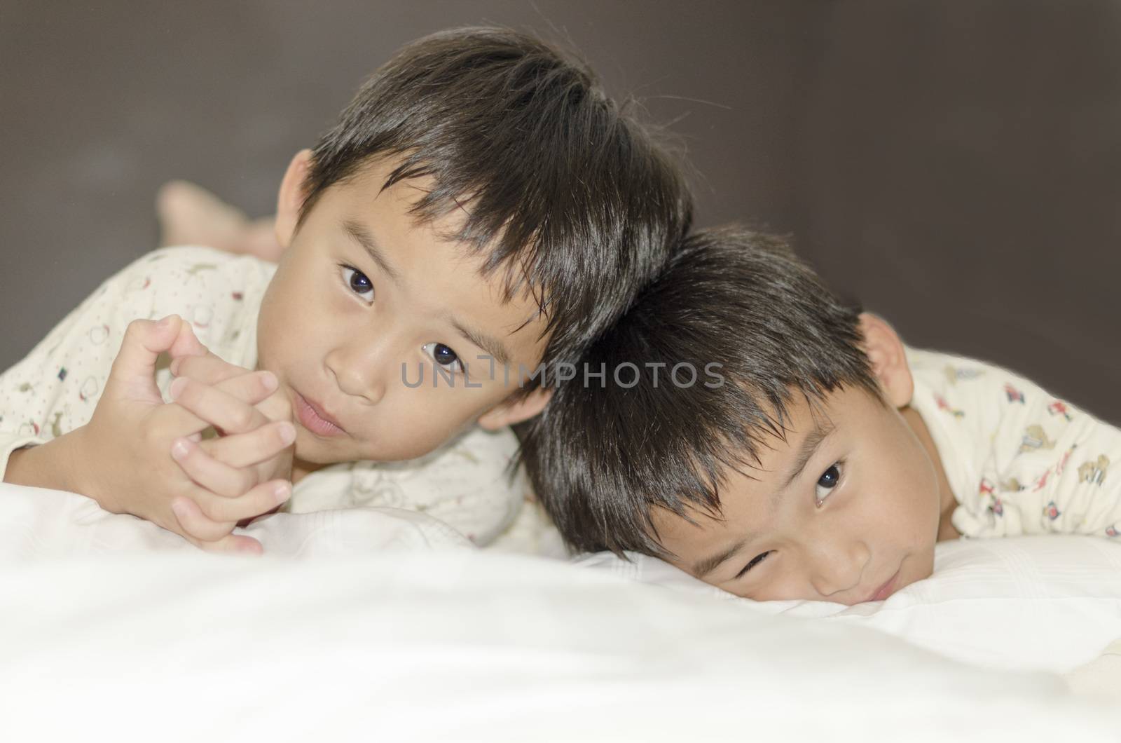 two twins brothers lying on bed by FrankyLiu