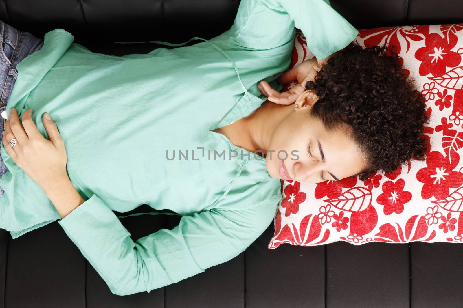 A jung brazilian woman sleeping on the sofa.