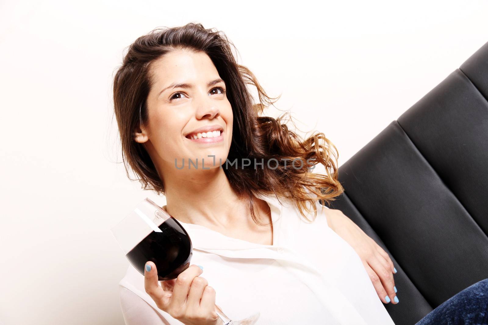 Portrait of a beautiful, latin Woman drinking red wine.