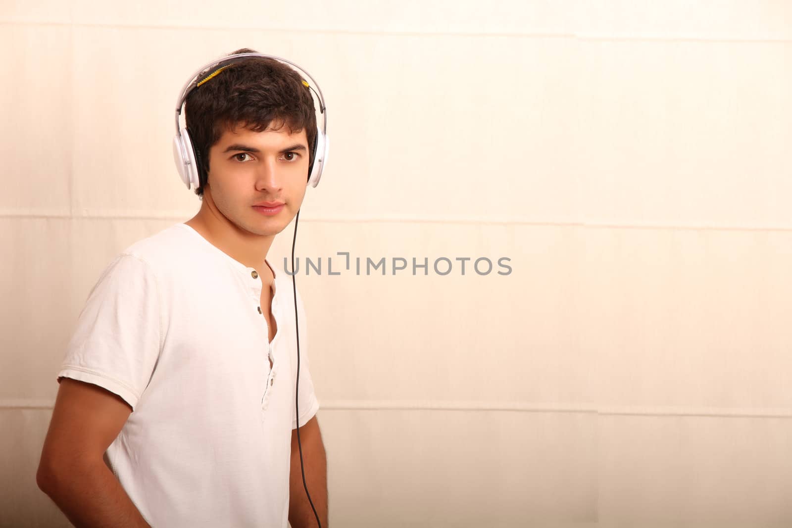 A young, latin man with a Tablet PC and headphones
