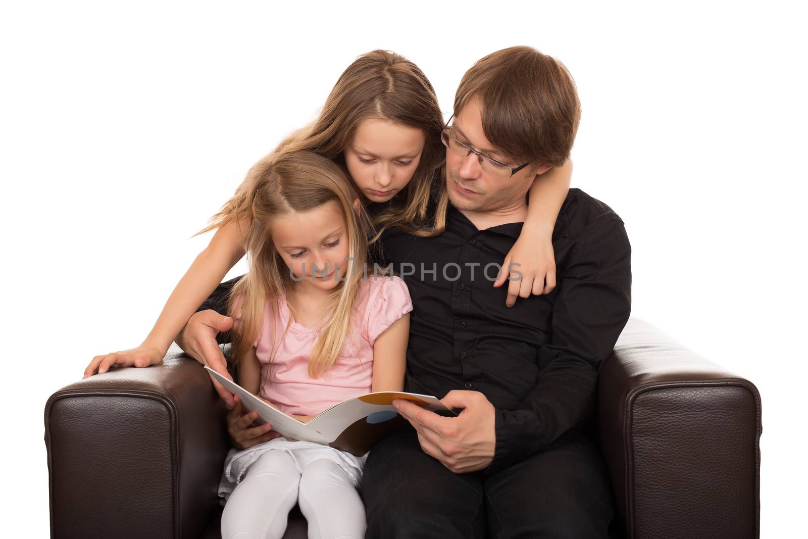 Family reading a story before going sleeping in a brown designed armchair. Isolated on white background.