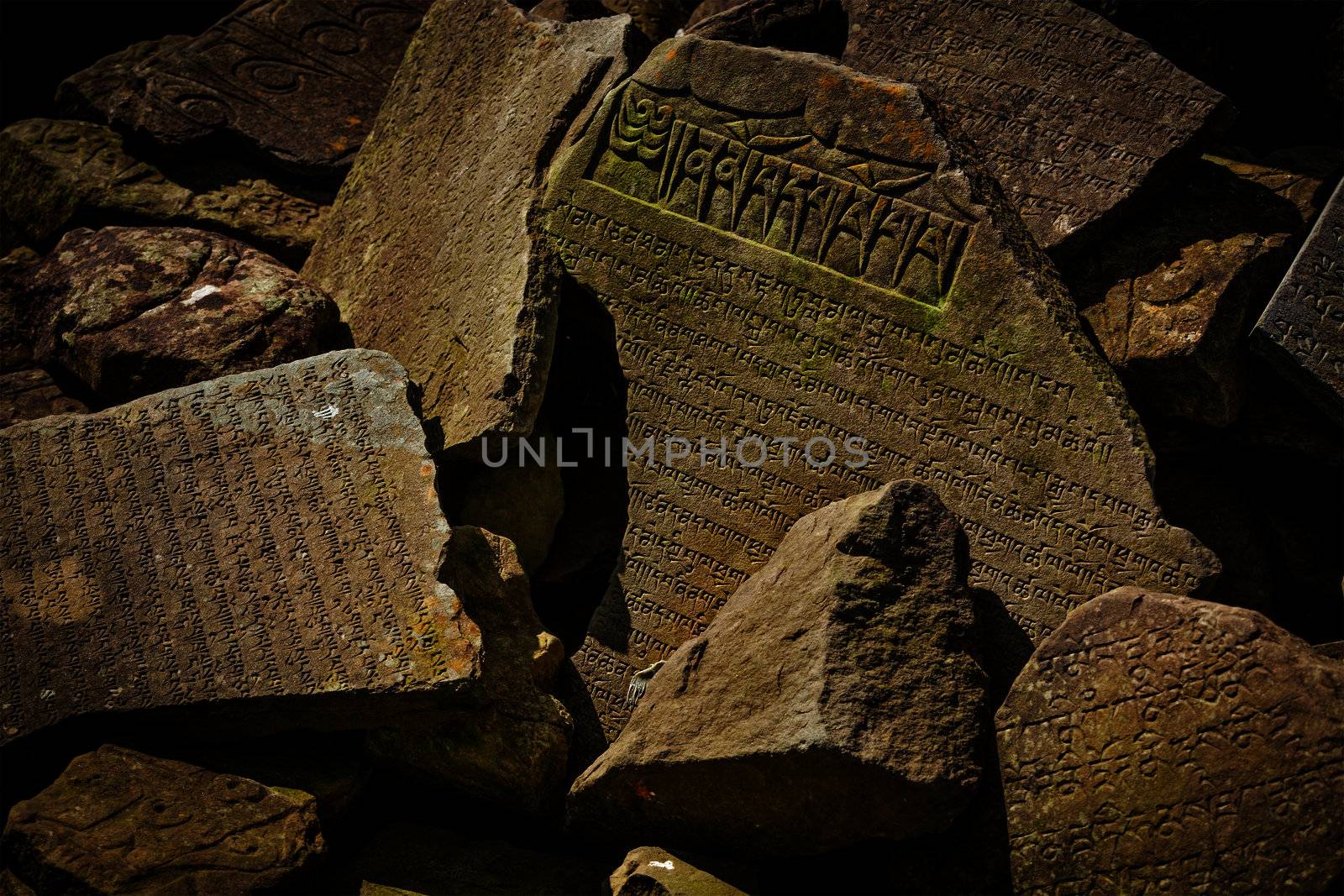 Buddhist prayer mantras on stones in Tibetan Buddhism temple