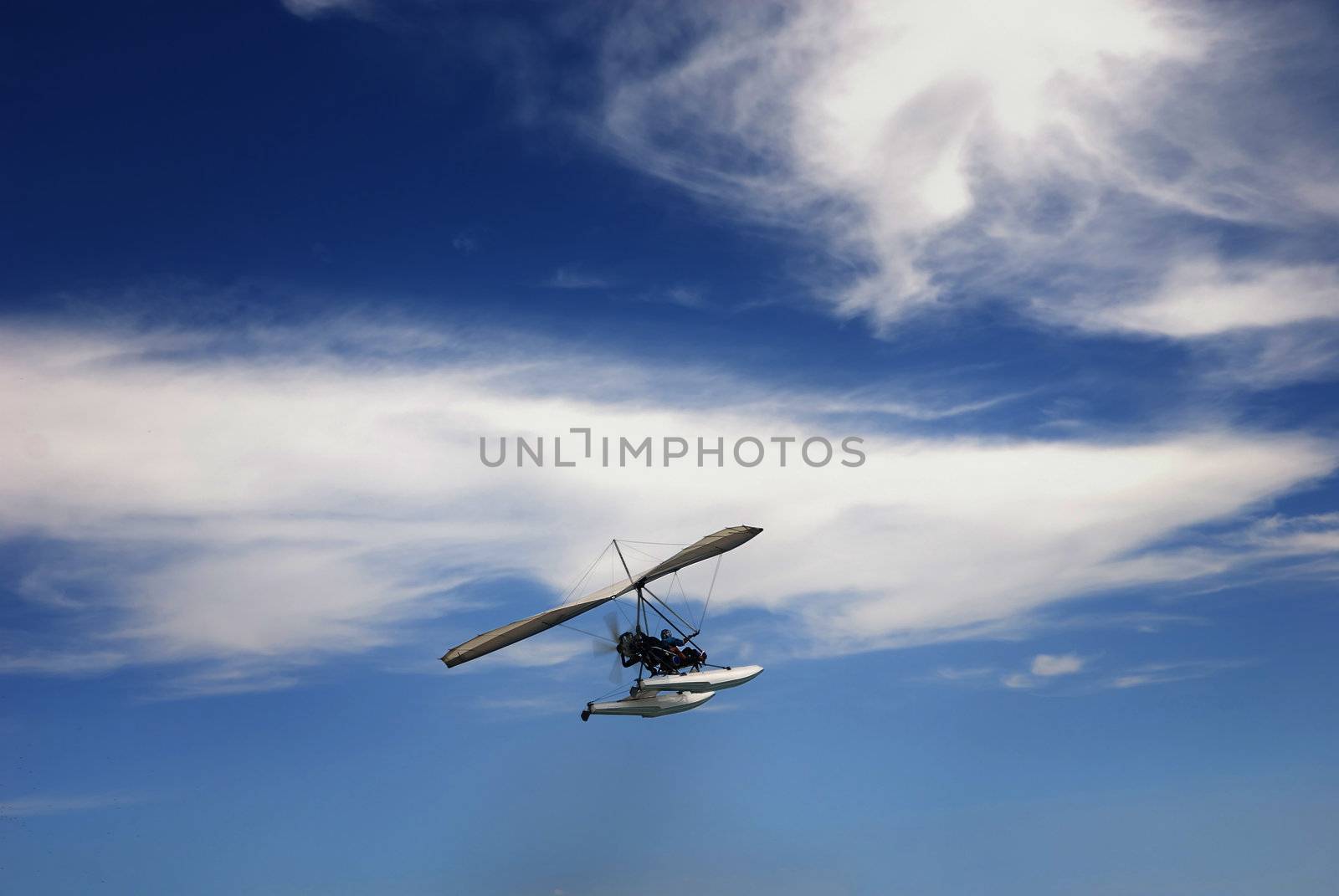 Close-up photo of the hang-glider flying in the cloudy sky