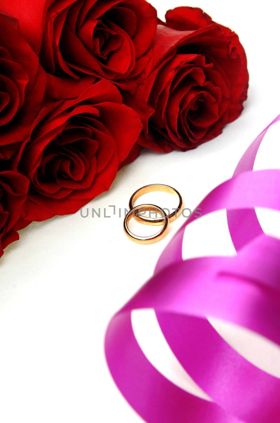 Bunch of flowers and wedding rings with ribbon