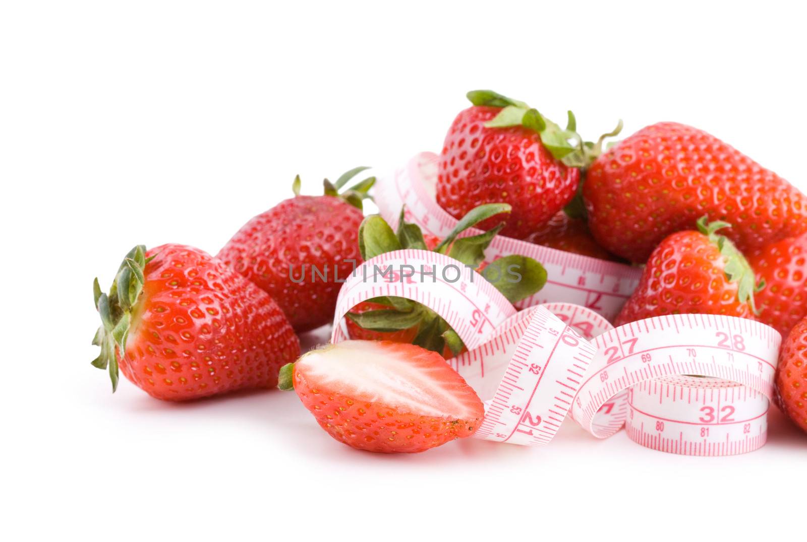 Fresh strawberries with measure tape isolated on white