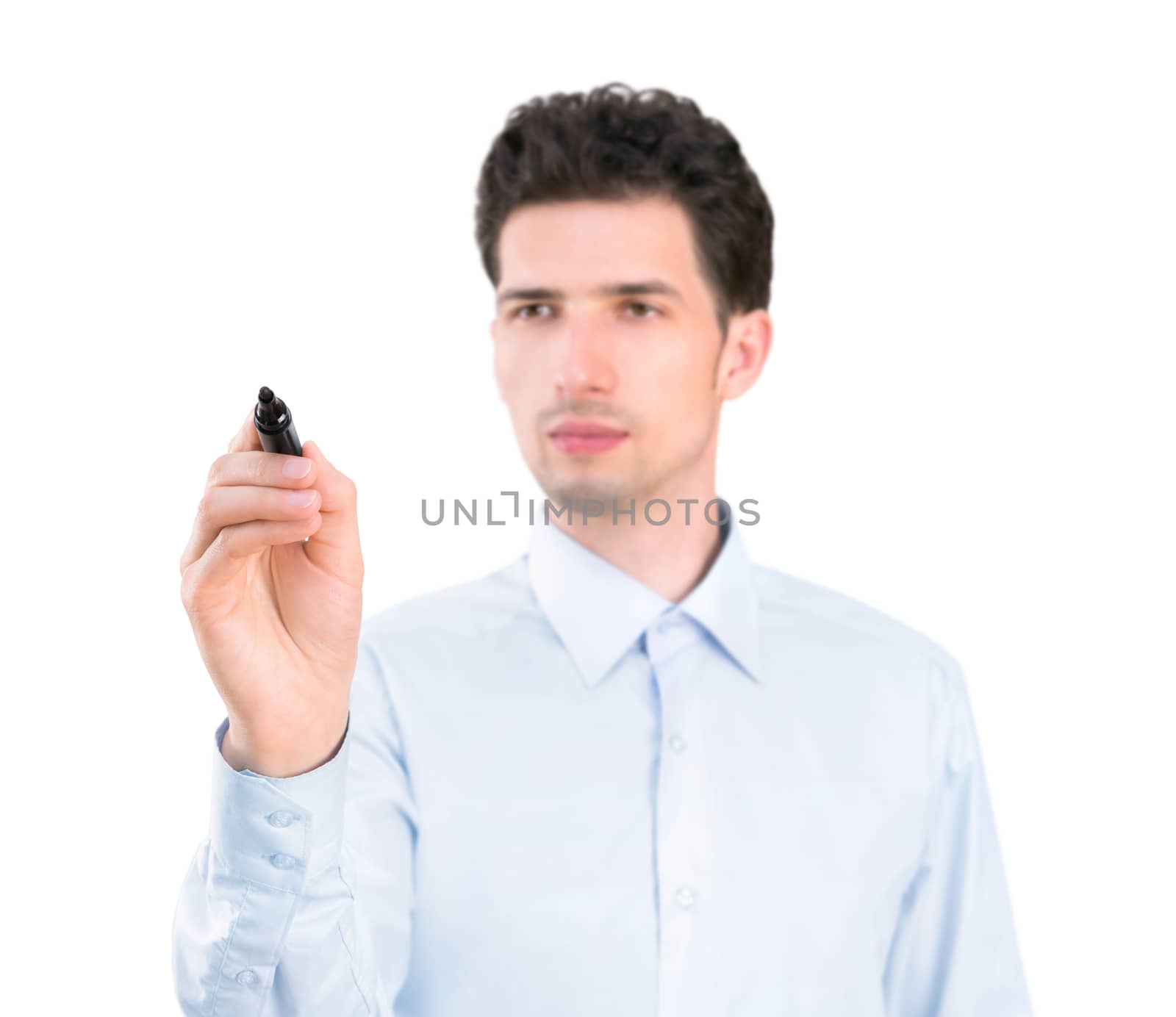 Portrait of a young pensive businessman holding a marker and writing on the empty copyspace. Isolated on white background.