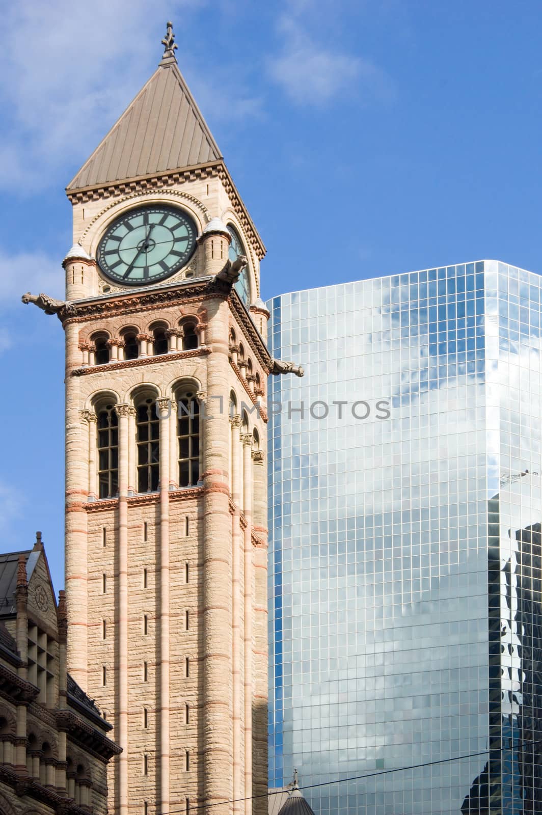 Modern building and old tower on blue sky background