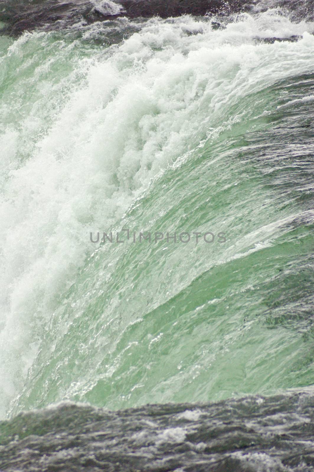 Blue-green water, falling down from Niagara falls.