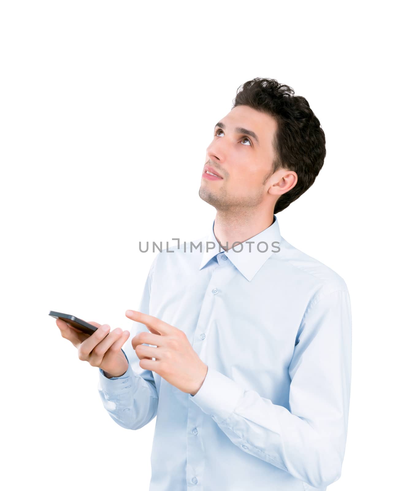Portrait of a young handsome businessman holding and pointing on mobile phone and looking up. Isolated on white background