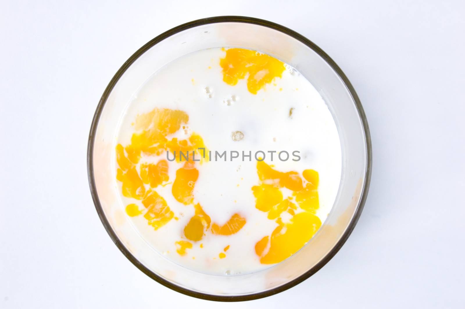 Mix of Raw eggs and mikk in glass bowl.